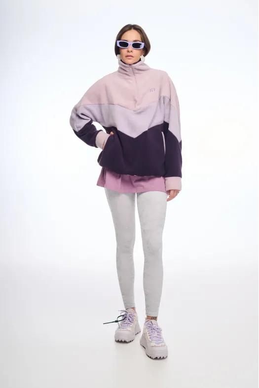 Person wearing a two-tone jacket with a white background