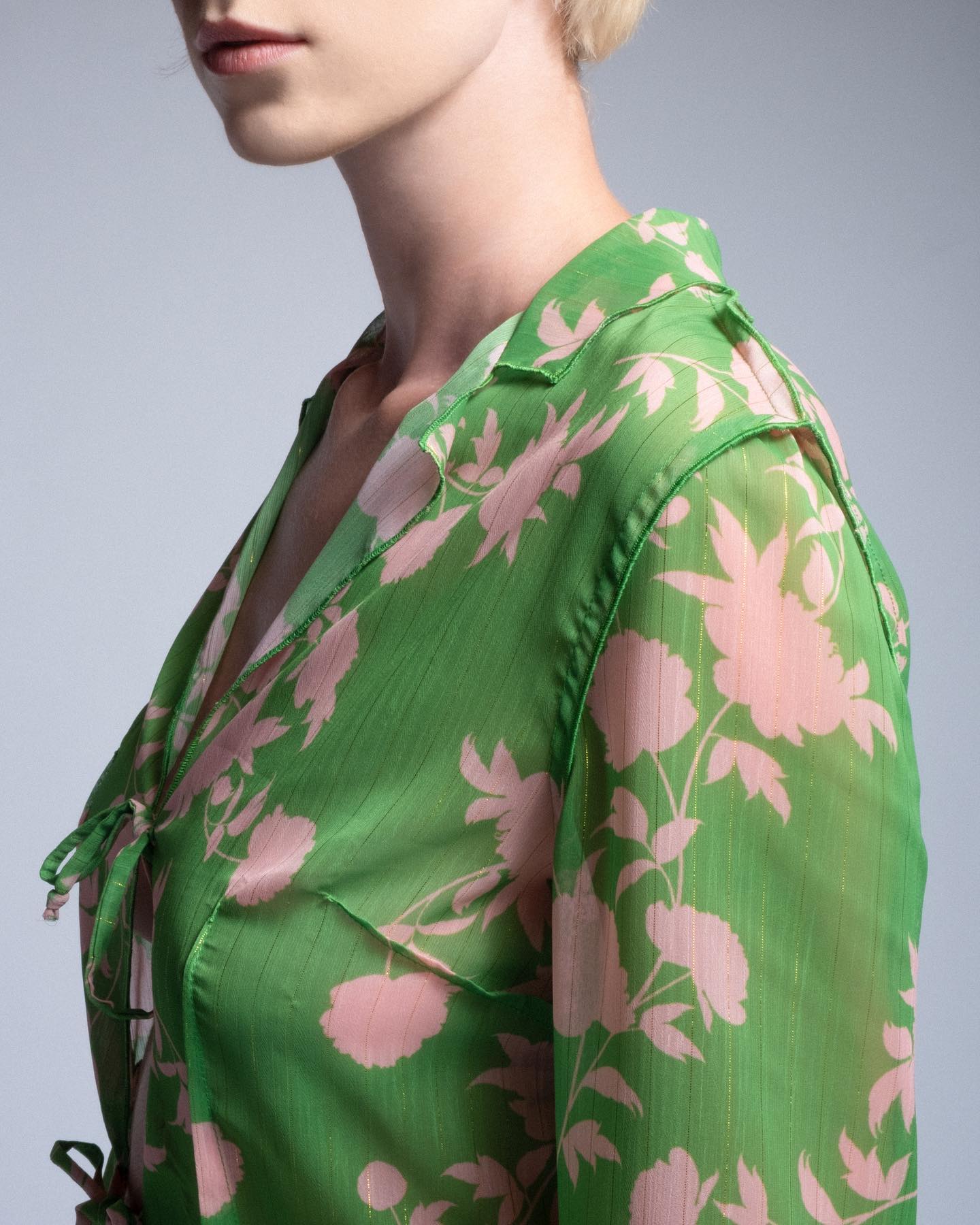 Green floral patterned garment on a plain background