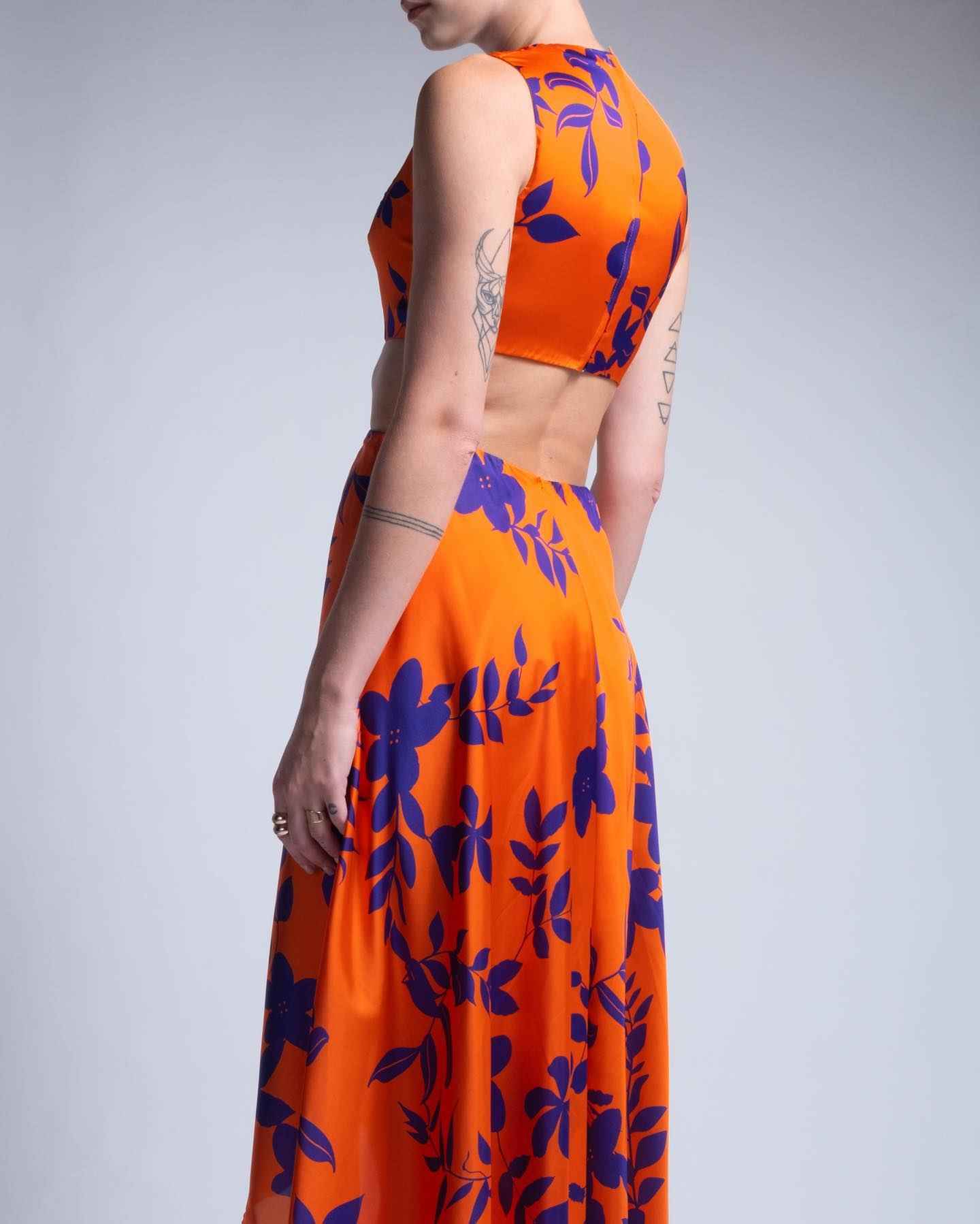 Orange dress with blue floral pattern on a plain background
