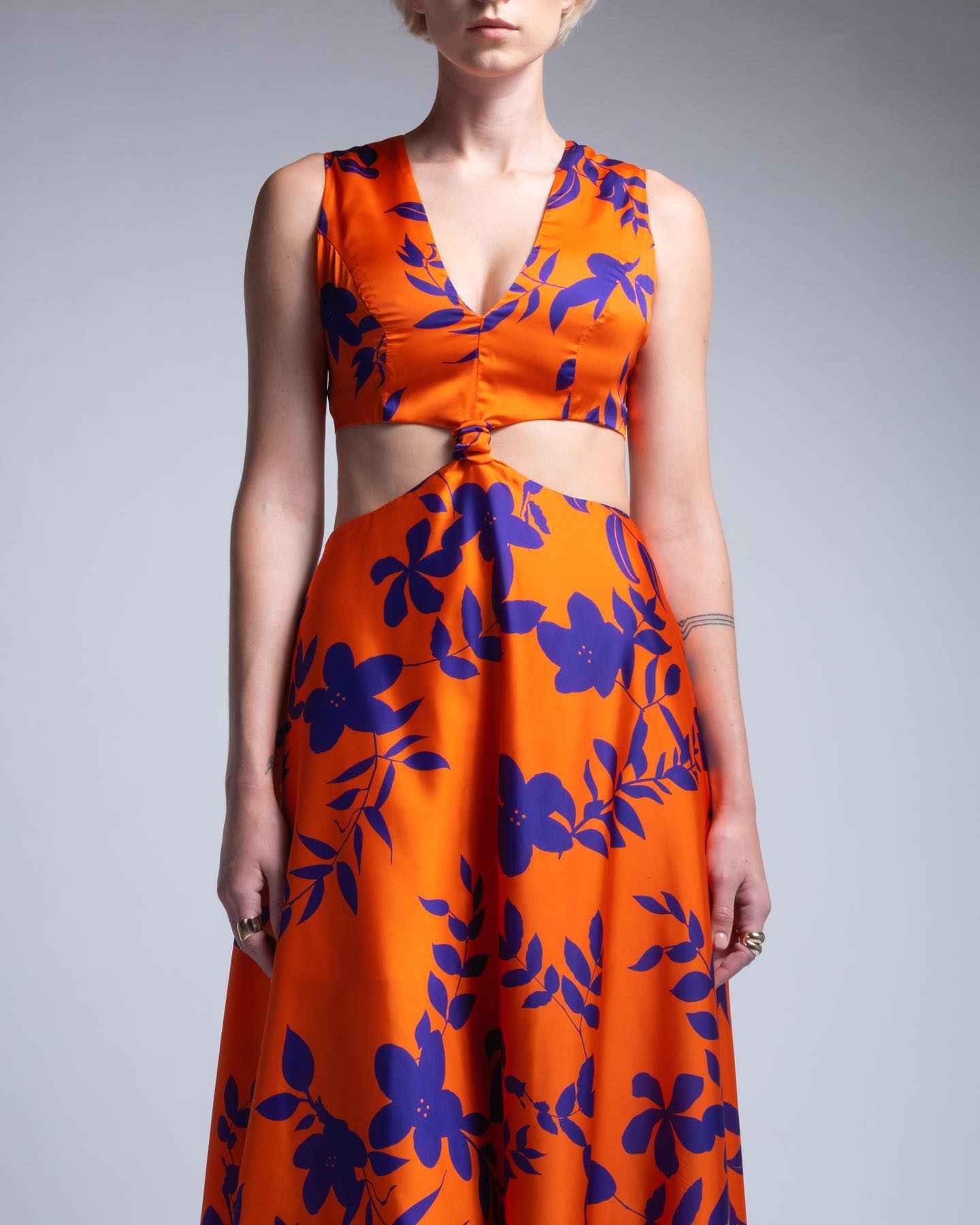 Orange outfit with blue floral patterns on a plain background