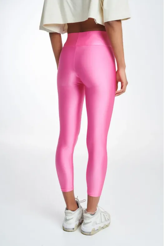 Person wearing bright pink leggings on a white background