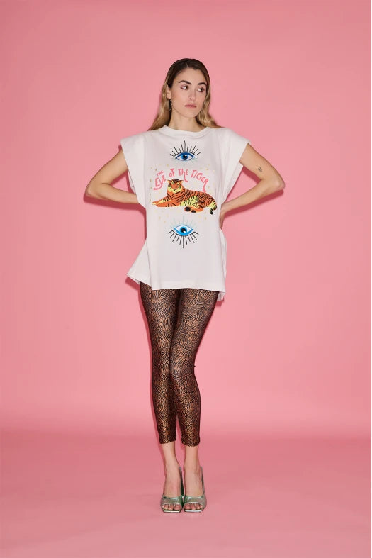 Woman wearing a white t-shirt with a graphic design on a pink background