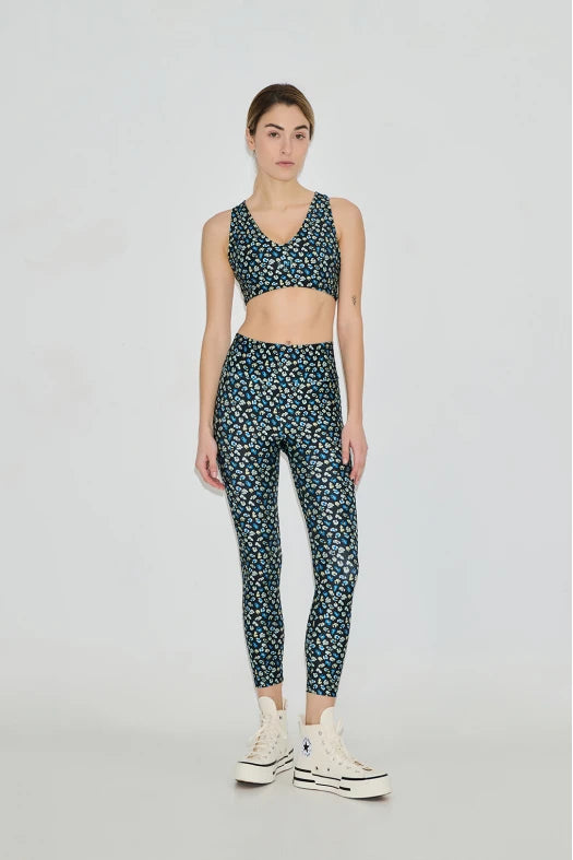 Woman wearing a patterned athletic outfit on a white background