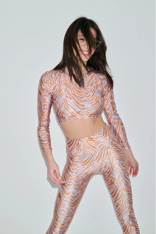 Person wearing a patterned outfit on a plain background