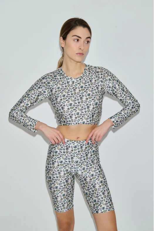 Woman wearing a leopard print athletic outfit on a plain background