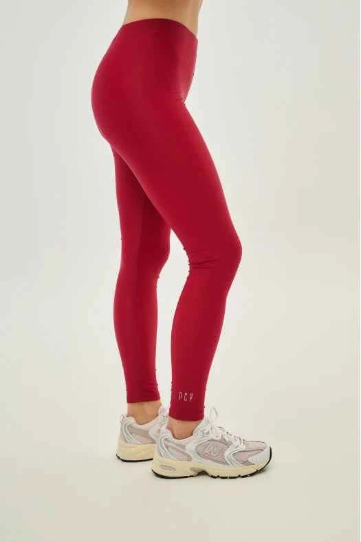Red leggings worn by a person on a white background