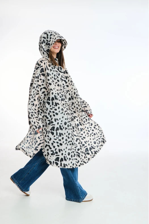 Person wearing a leopard print raincoat on a white background