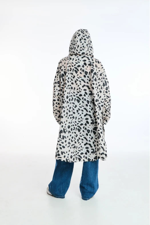 Person wearing a leopard print raincoat on a white background