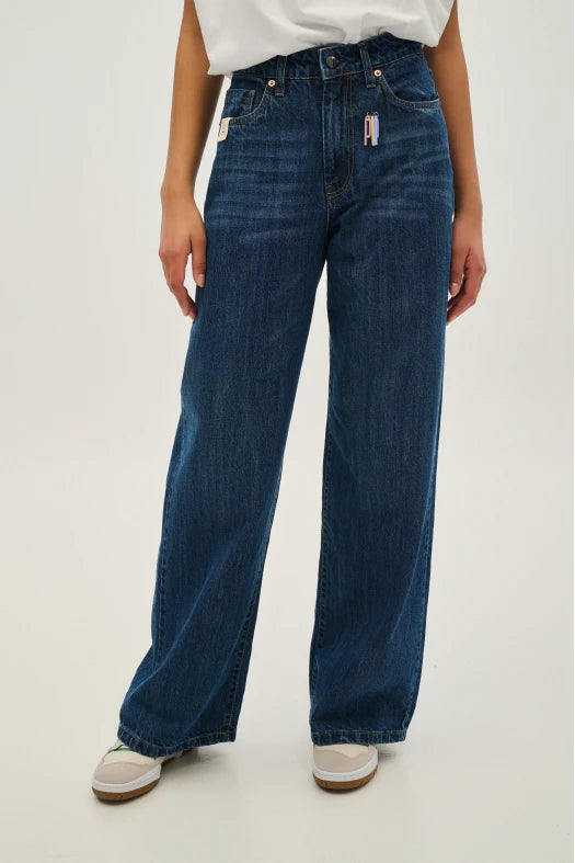 Person wearing blue jeans on a white background