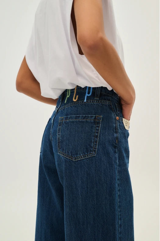 Person wearing blue jeans with a white background