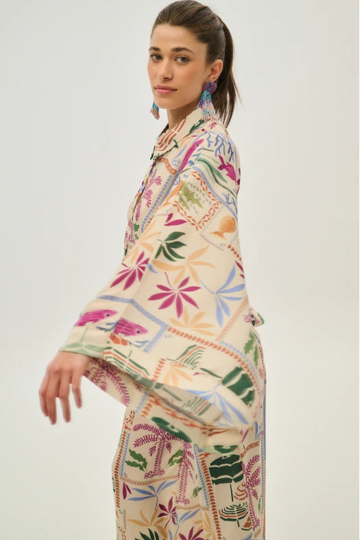 Woman wearing a colorful patterned outfit on a white background