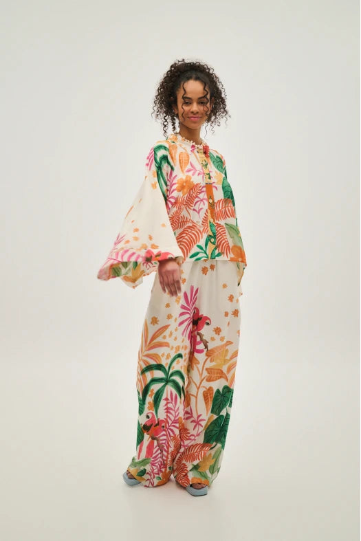 Person wearing a colorful floral outfit on a white background