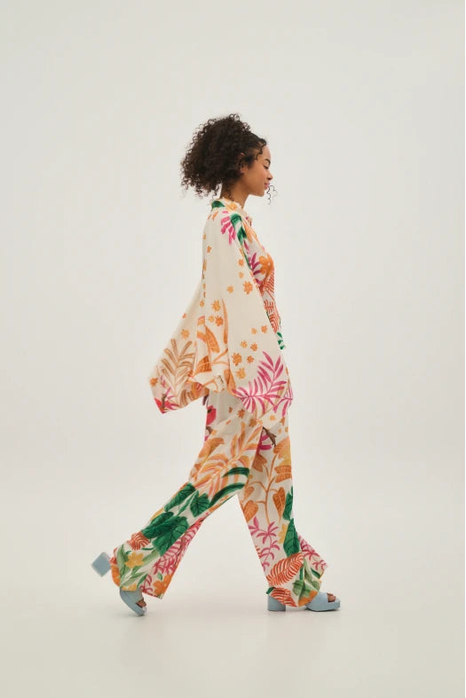 Woman wearing a colorful floral outfit on a white background