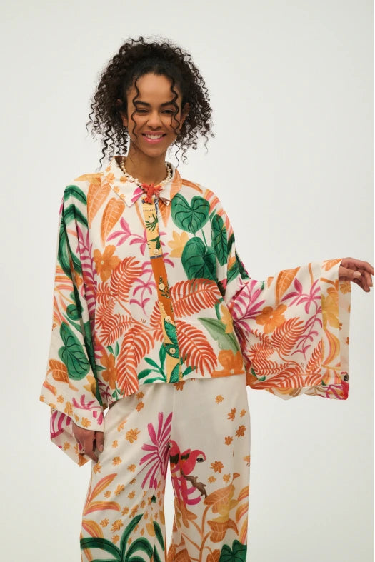 Woman wearing a colorful floral outfit on a white background