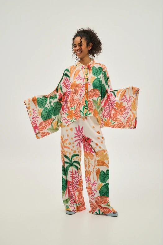 Person wearing a colorful floral outfit on a white background