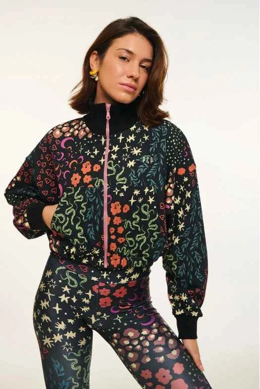 Woman wearing a colorful floral-patterned outfit on a white background