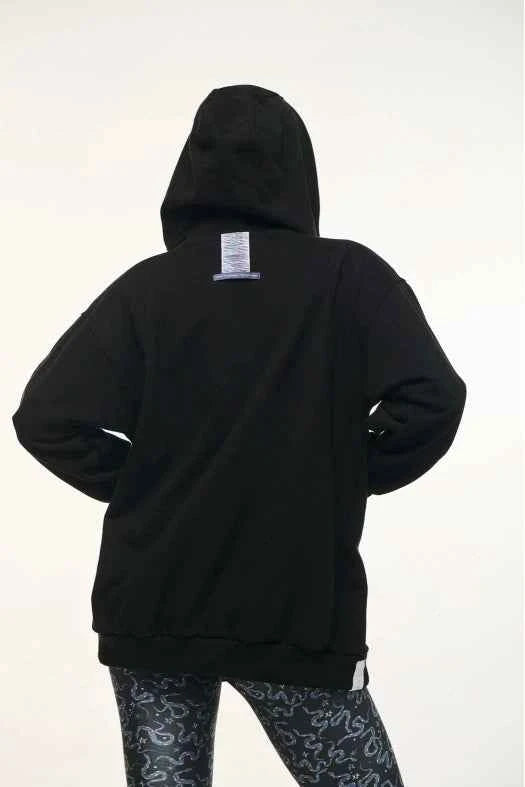 Black hoodie with a visible brand label on the back against a white background