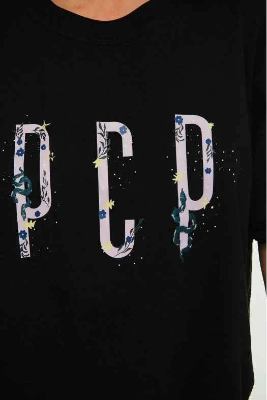 Black t-shirt with 'PCP' design featuring floral elements on a plain background