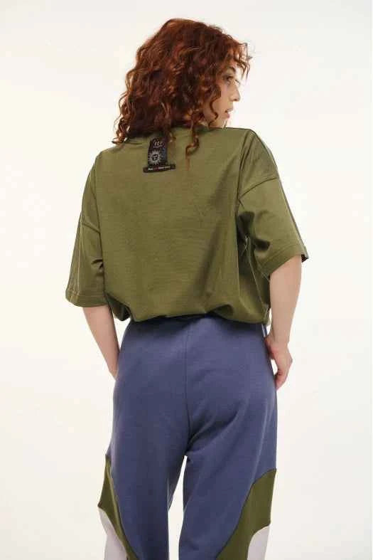 Person wearing a green and blue outfit with a white background