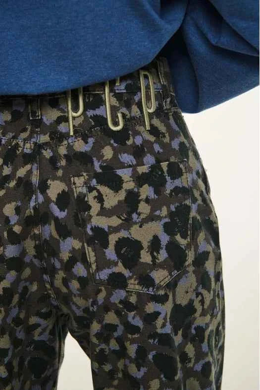 Close-up of patterned pants with a blue top on a white background