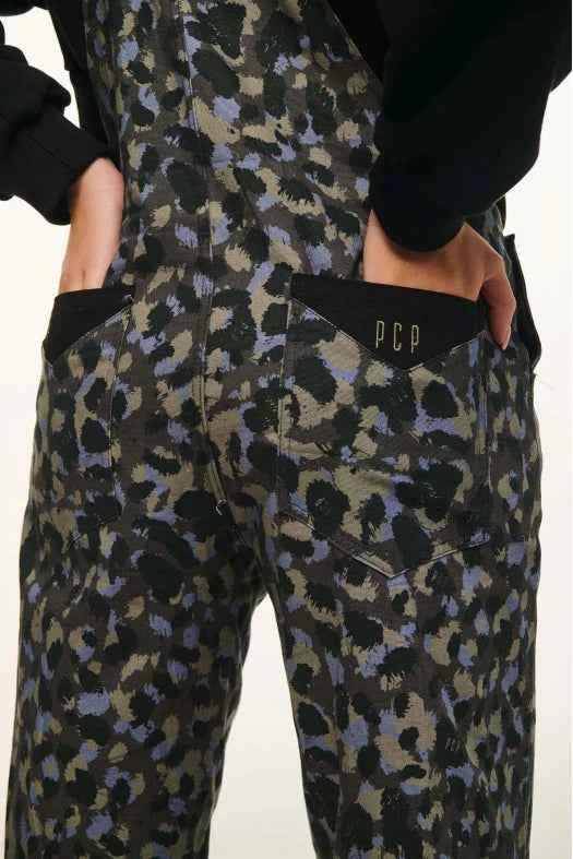 Camouflage-patterned pants with a brand logo on a plain background