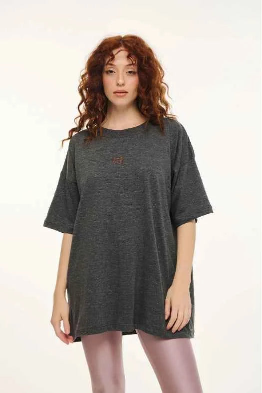Woman wearing a gray oversized t-shirt on a white background
