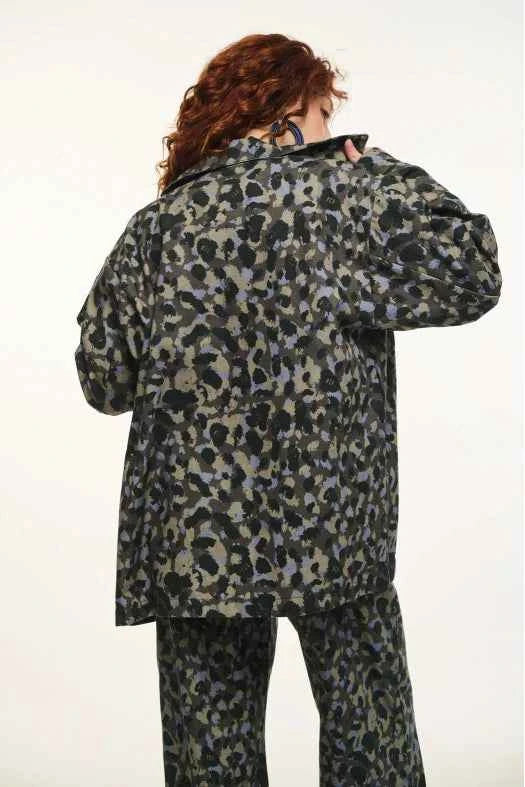 Person wearing a camouflage-patterned outfit on a white background