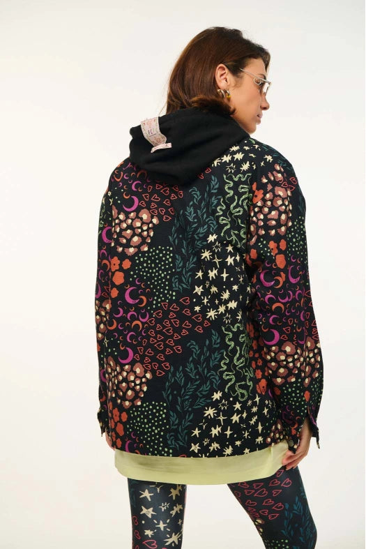 Person wearing a colorful patterned jacket on a white background