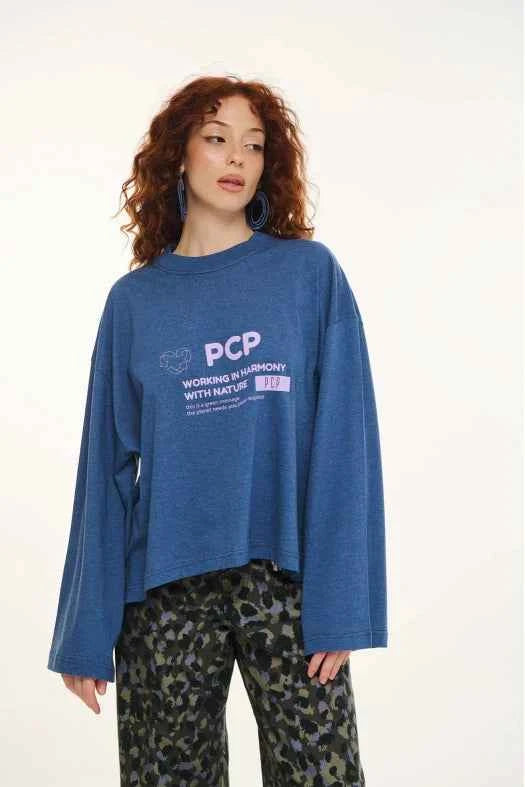 Person wearing a blue sweatshirt with 'PCP' logo on a white background