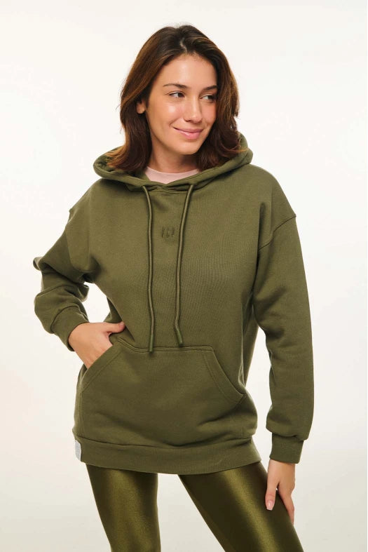Woman wearing an olive green hoodie on a white background