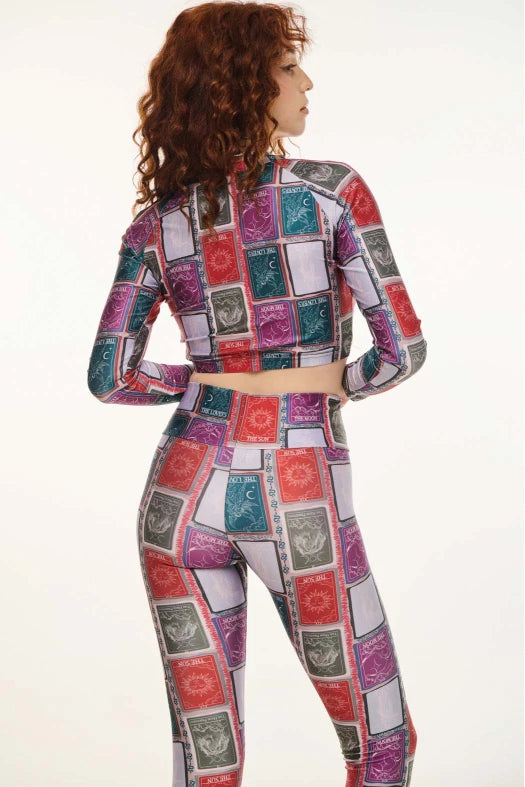 Woman wearing a colorful patchwork outfit on a white background