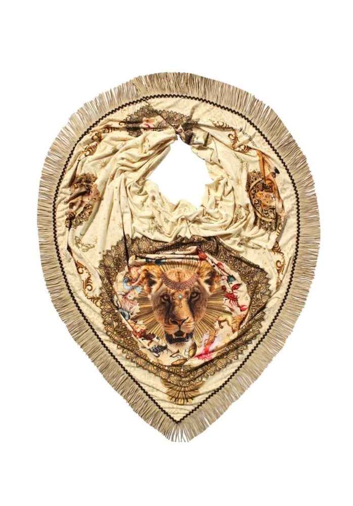 Decorative patch with lion emblem and fringe details on a white background