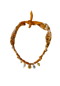 Badhnati Jewelry tangerine Colombiana fabric necklace with small gold-tone flower medallion, pearl and pale blue charm