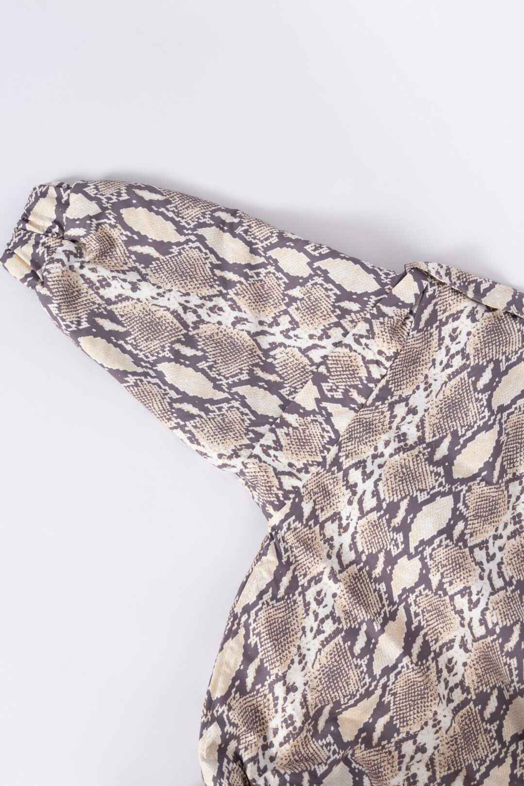 Close-up of a snake print long-sleeve shirt.
