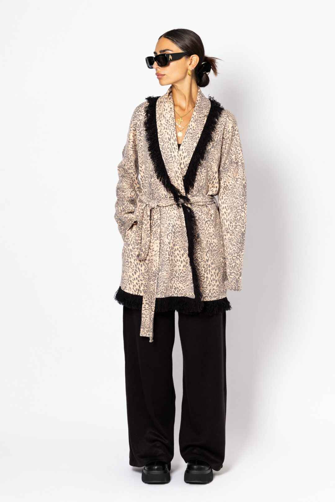 Knitted leopard print jacket with black fringes.