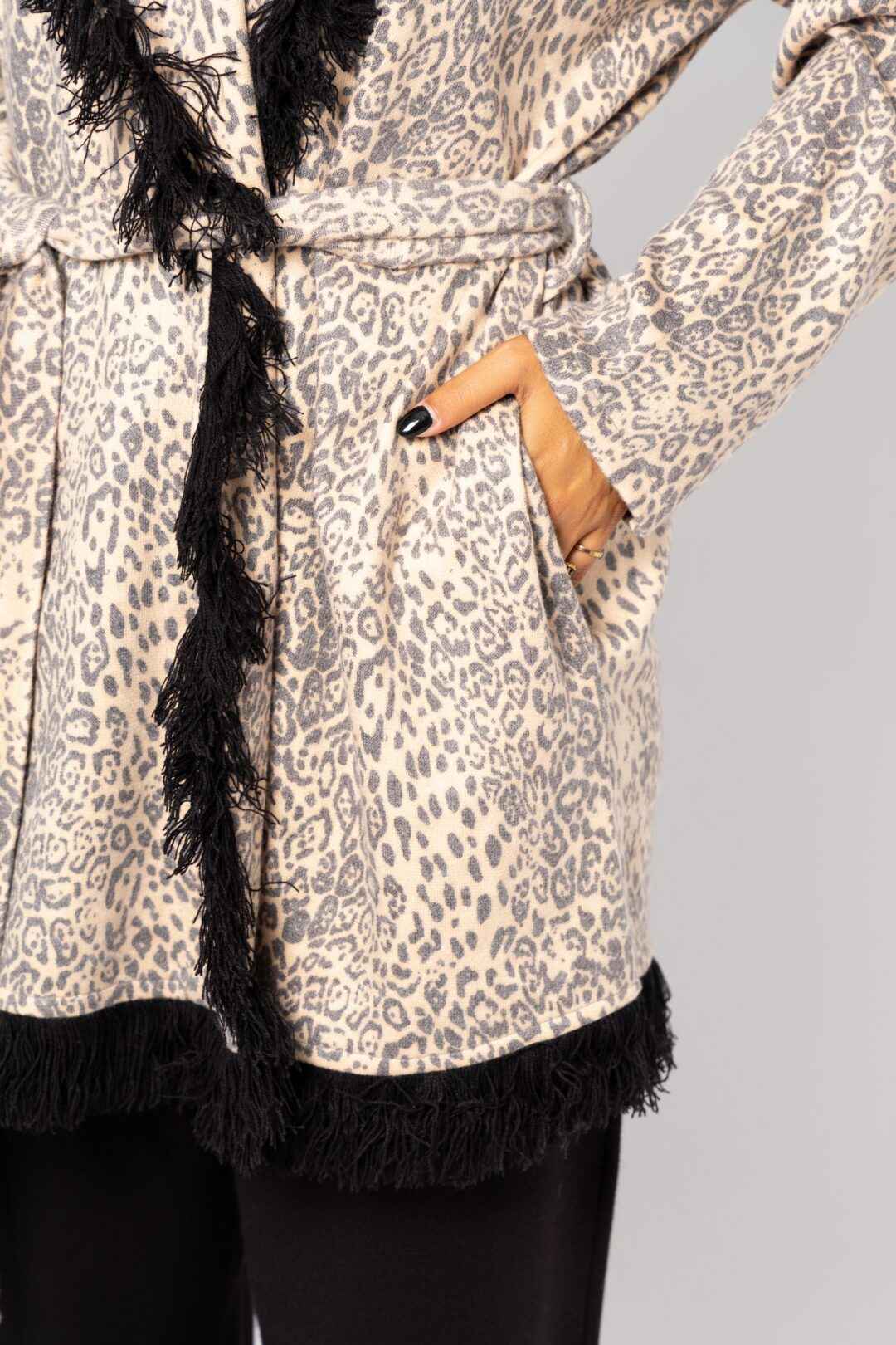 Knitted leopard print jacket with black fringes.