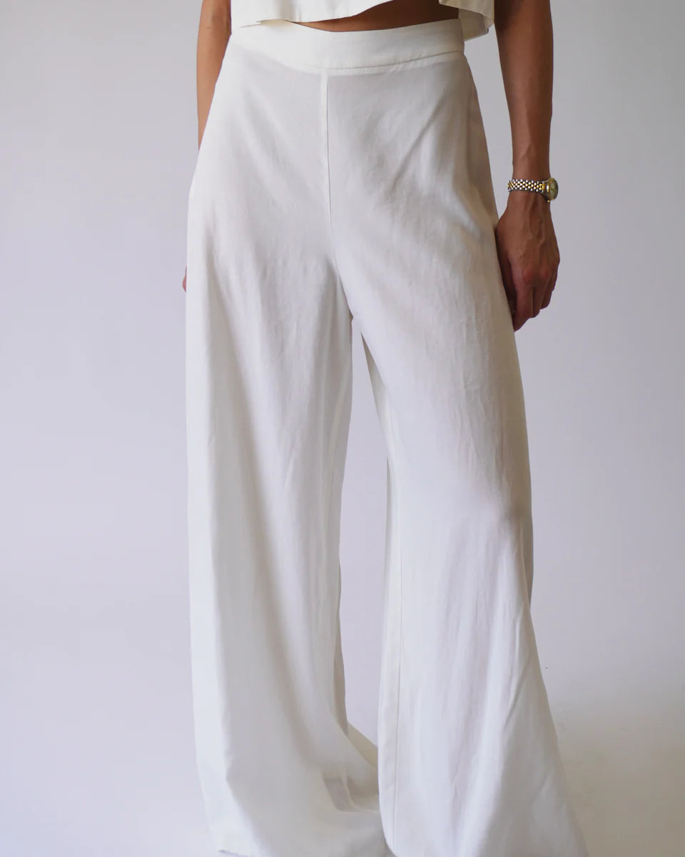 White wide-leg pants worn by a person on a plain background