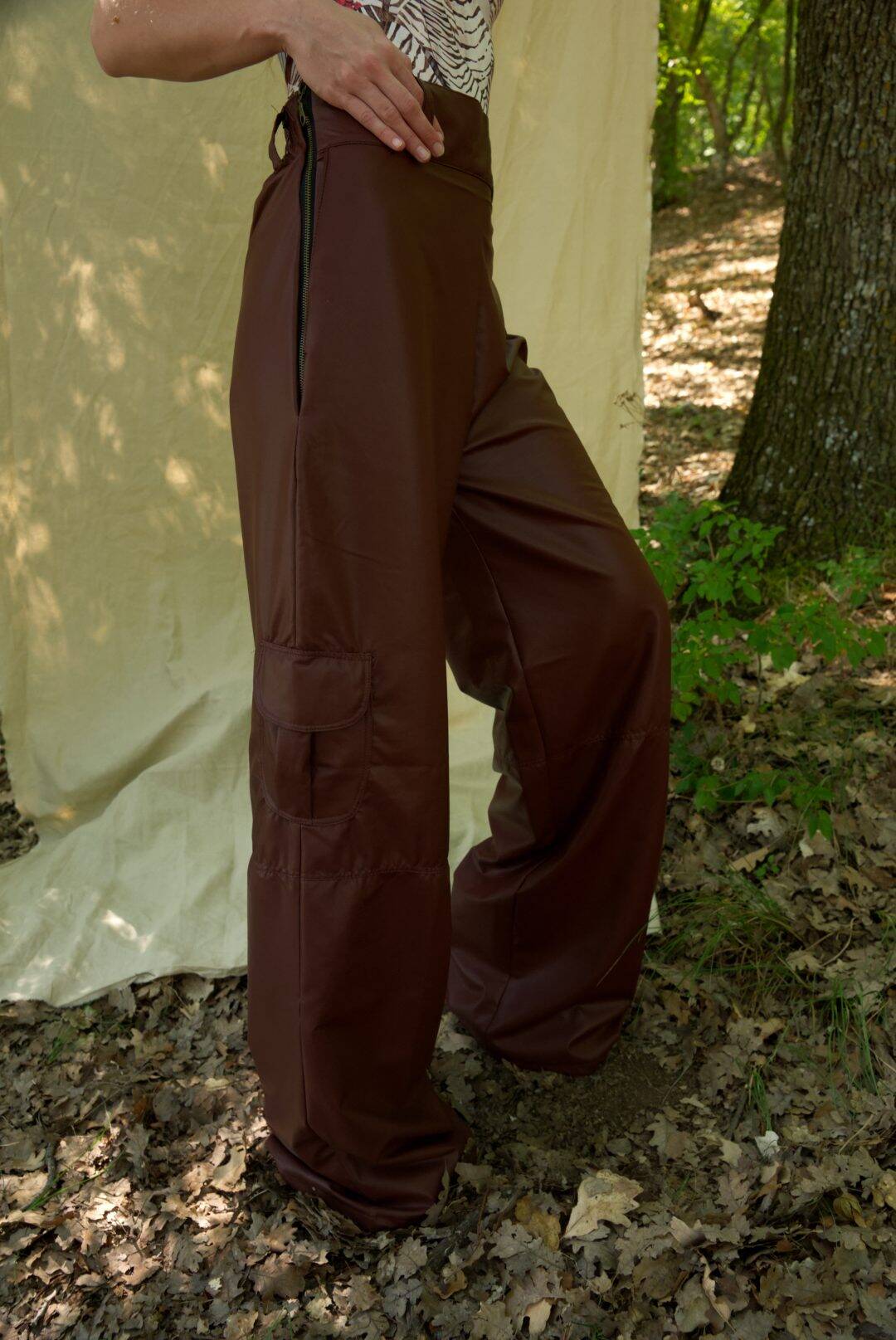 Brown wide-leg pants worn by a person in a forest setting