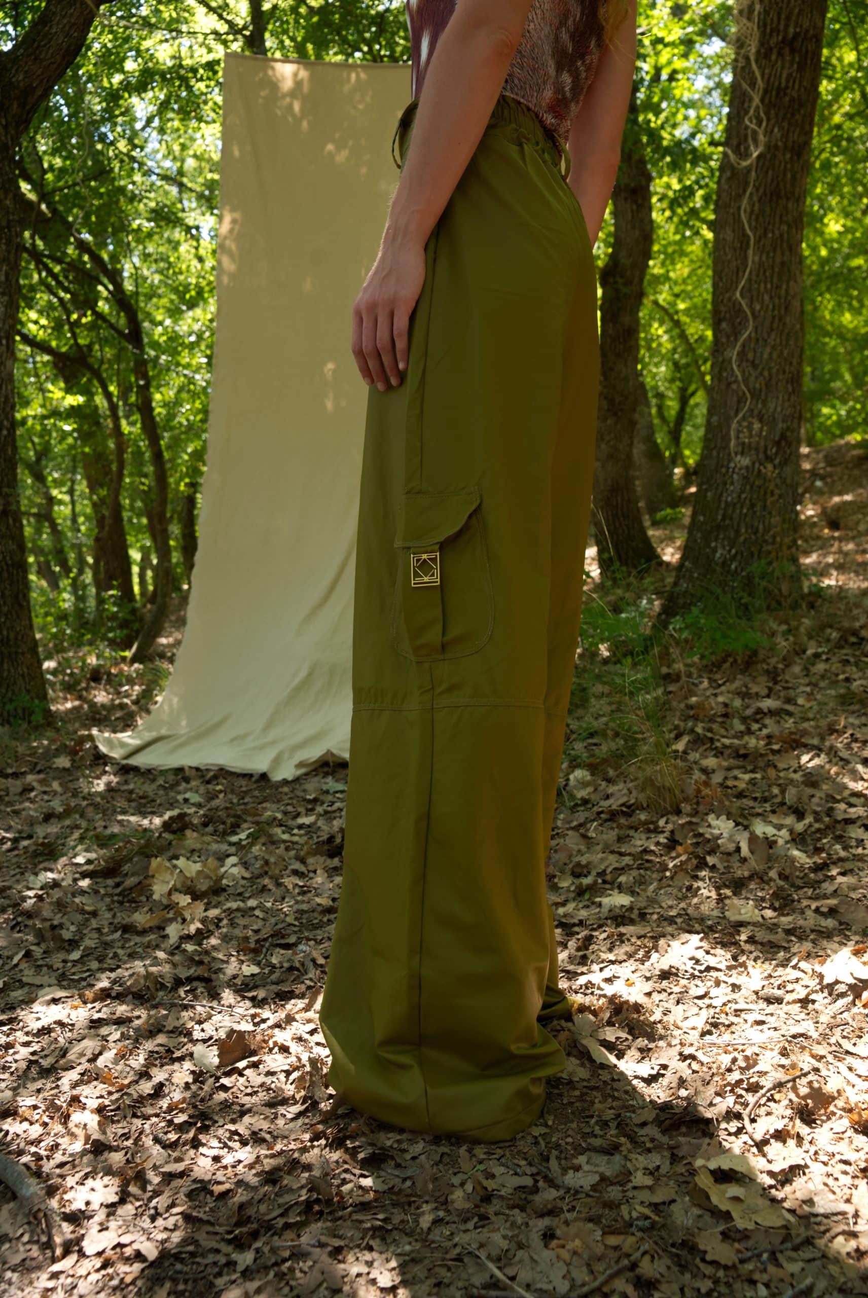 Person wearing green pants standing in a forest