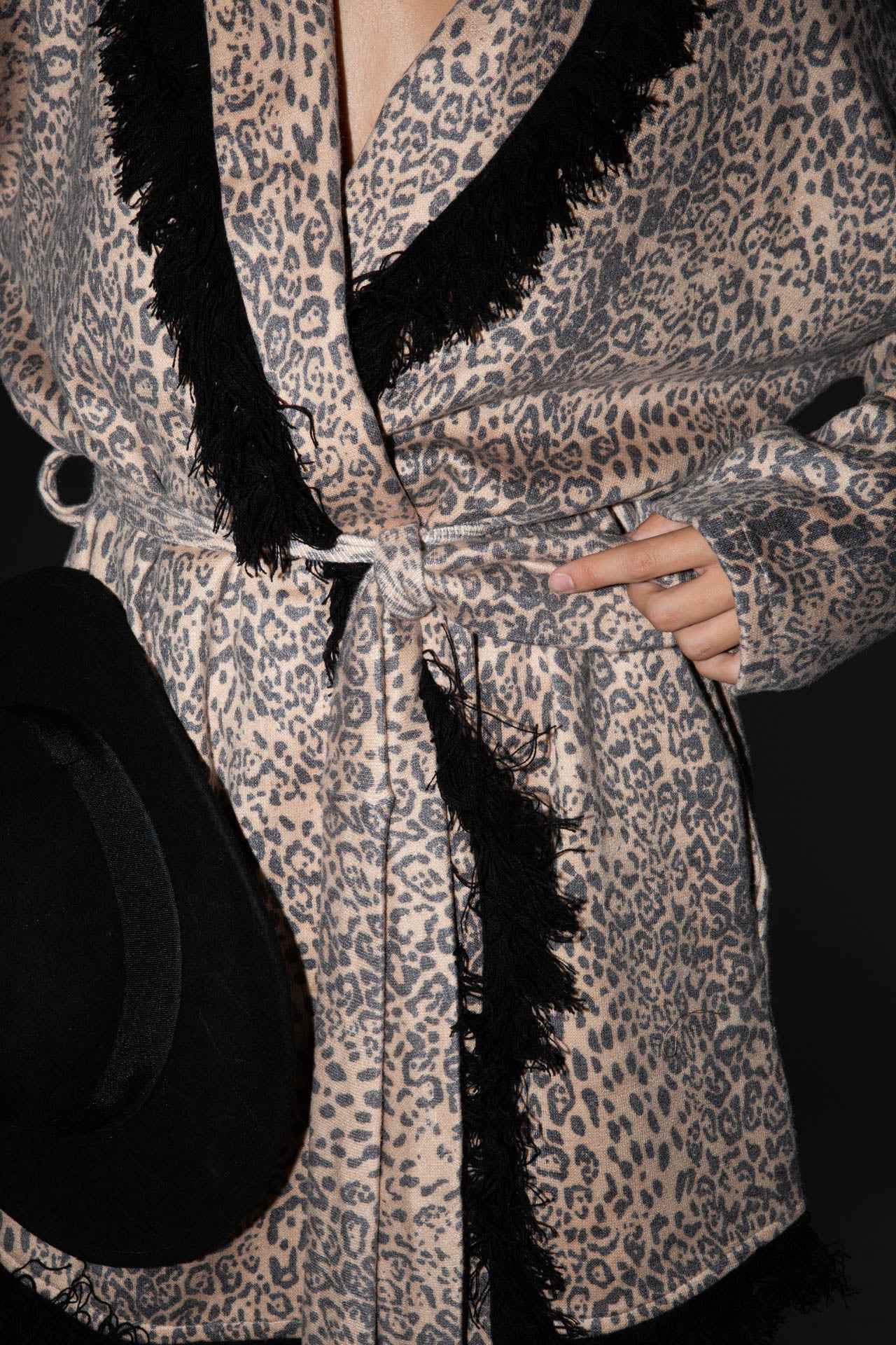 Knitted leopard print jacket with black fringes.
