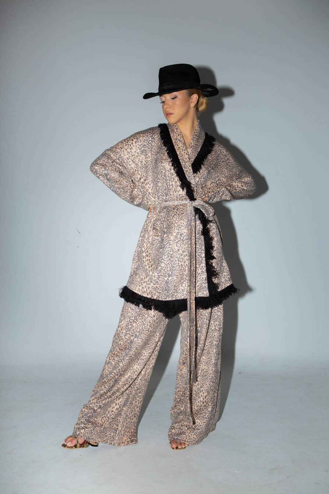 Knitted leopard print jacket with black fringes.