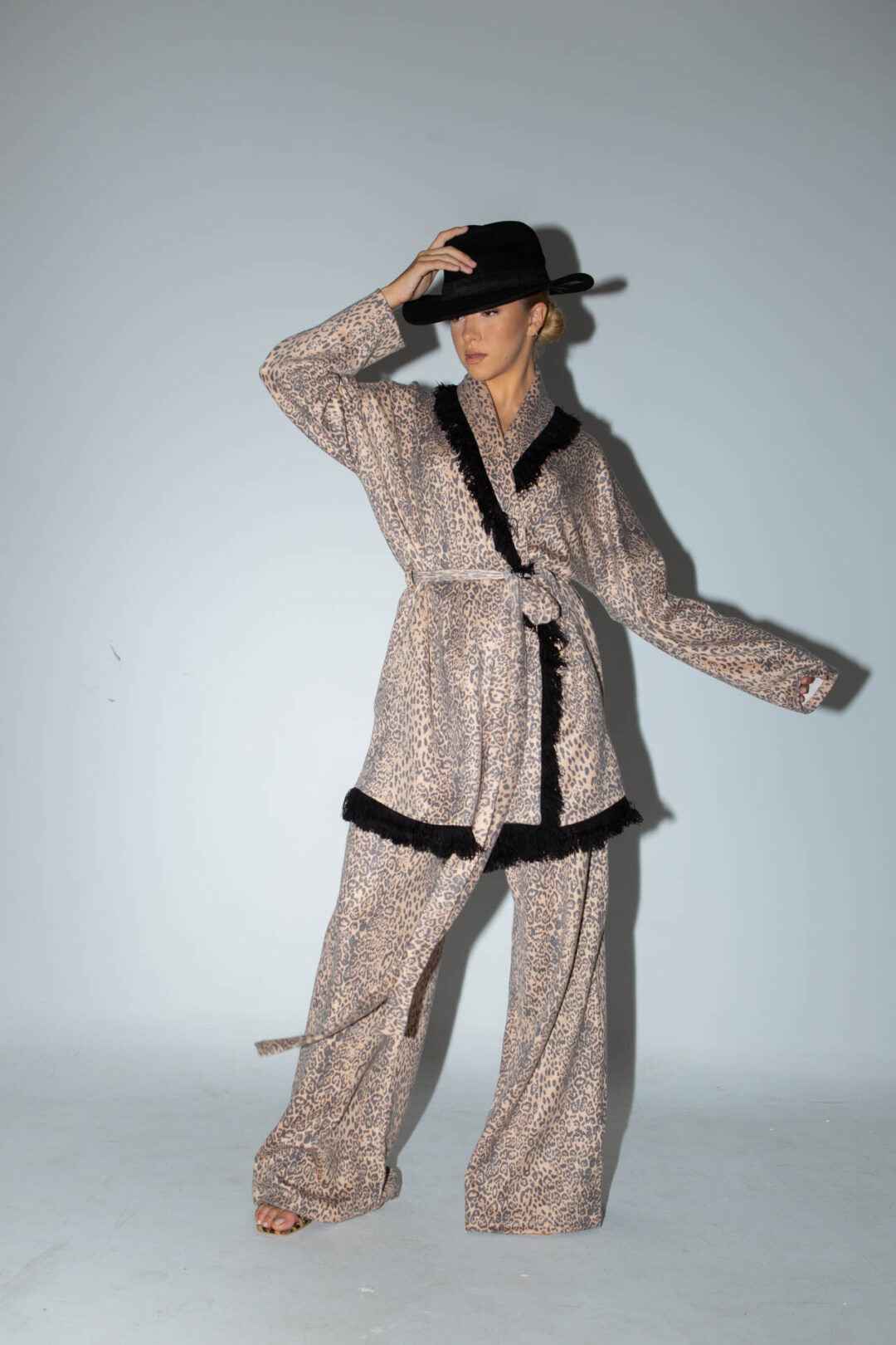 Knitted leopard print jacket with black fringes.