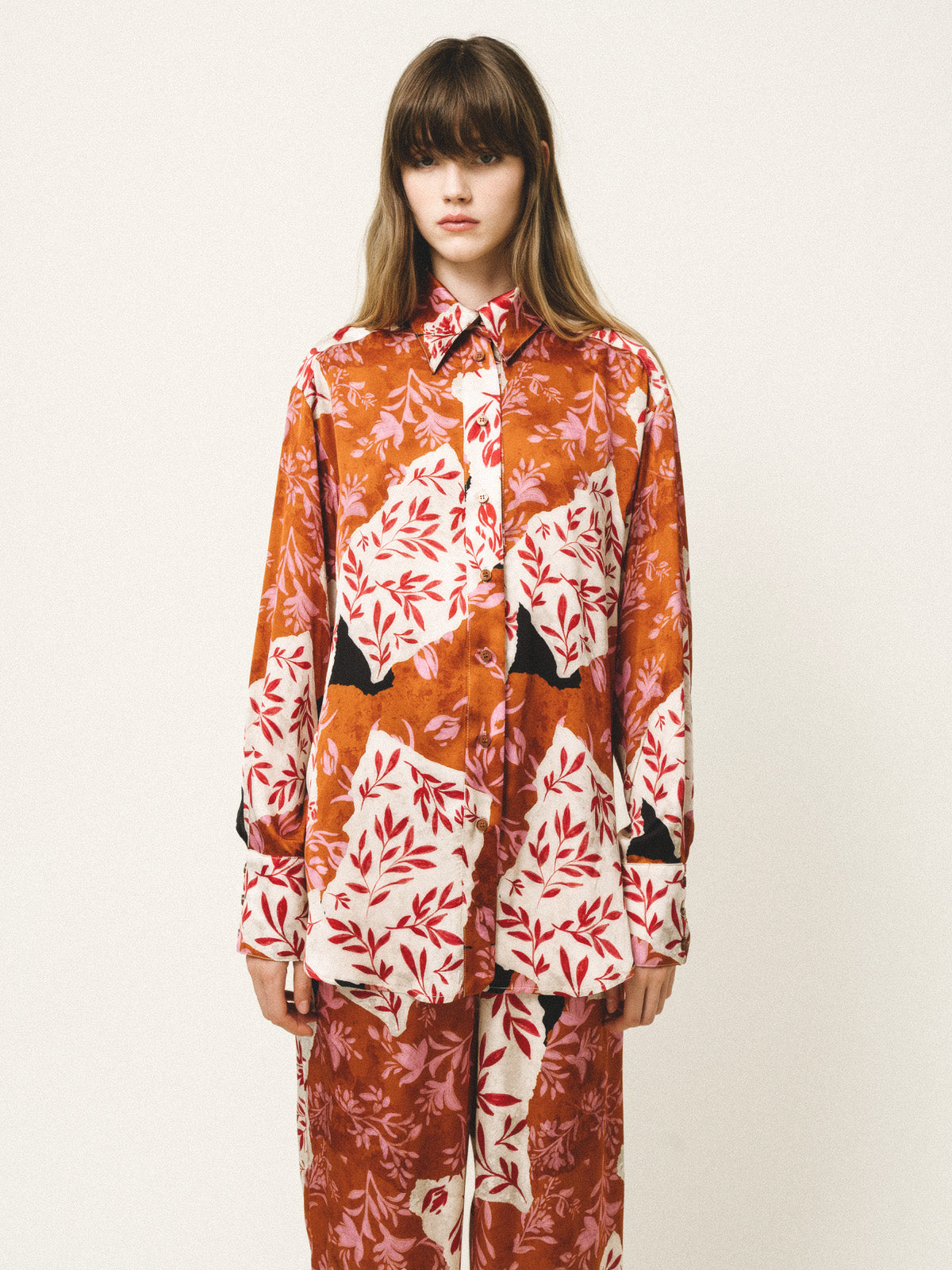 Model wearing a patterned outfit with a white background