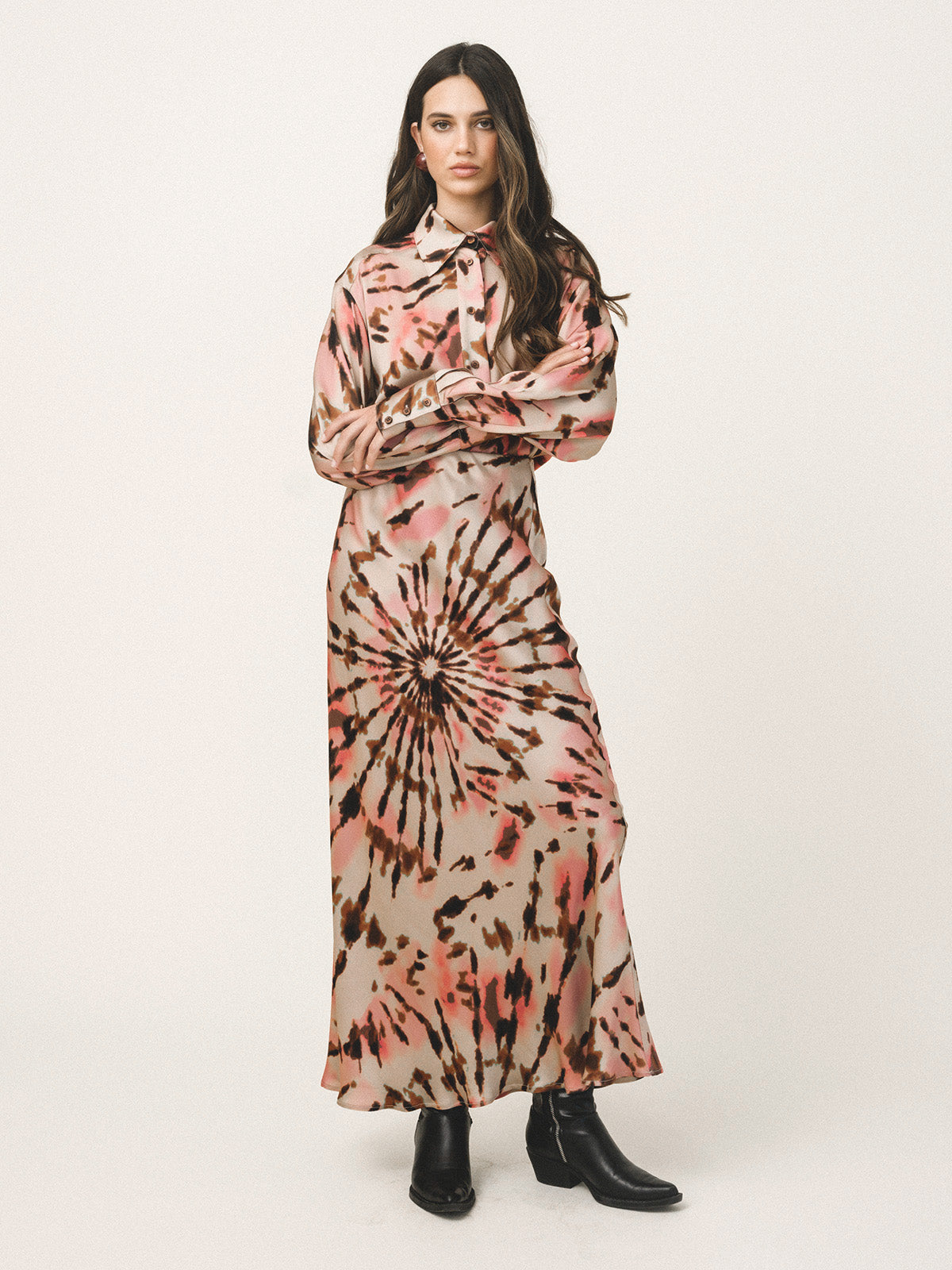 Woman wearing a tie-dye dress with a white background