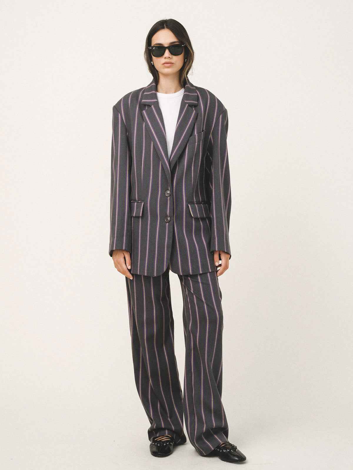 Person wearing a striped suit on a white background