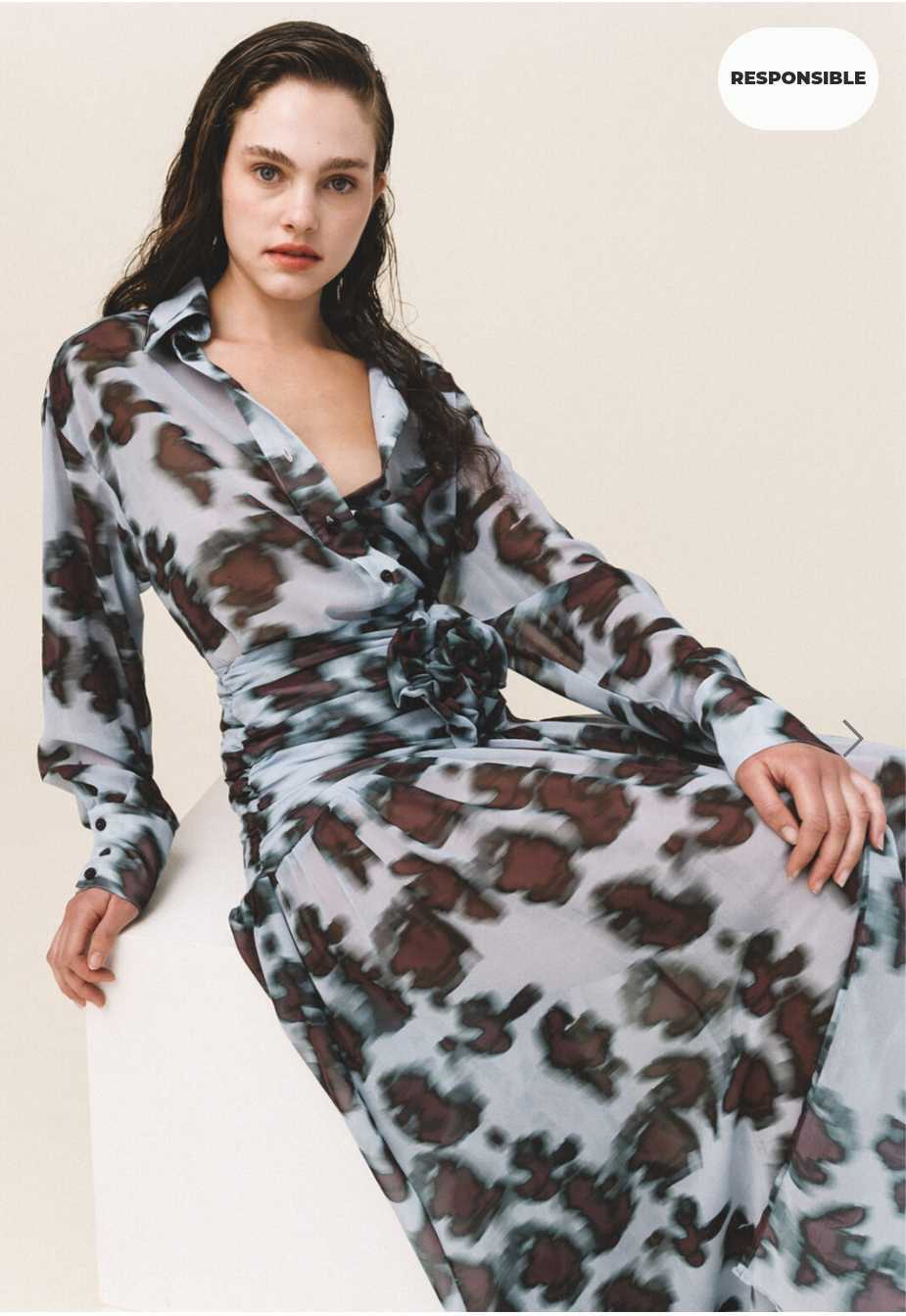 Woman with oversized sheer shirt with a geometric animal pattern