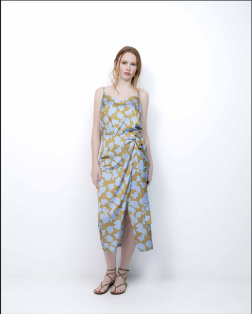 Woman wearing a patterned dress on a white background