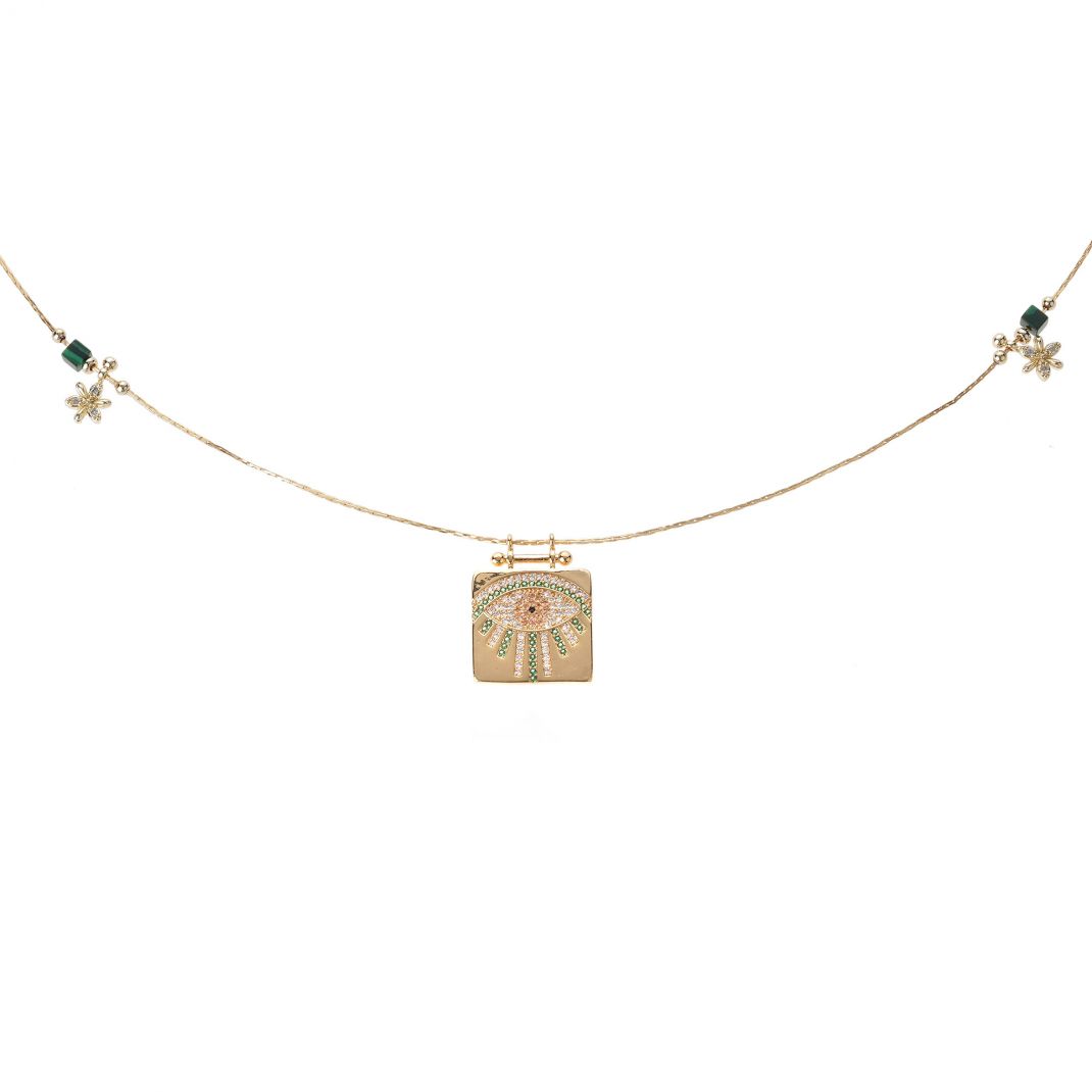 Necklace with a gold pendant featuring a floral design on a white background