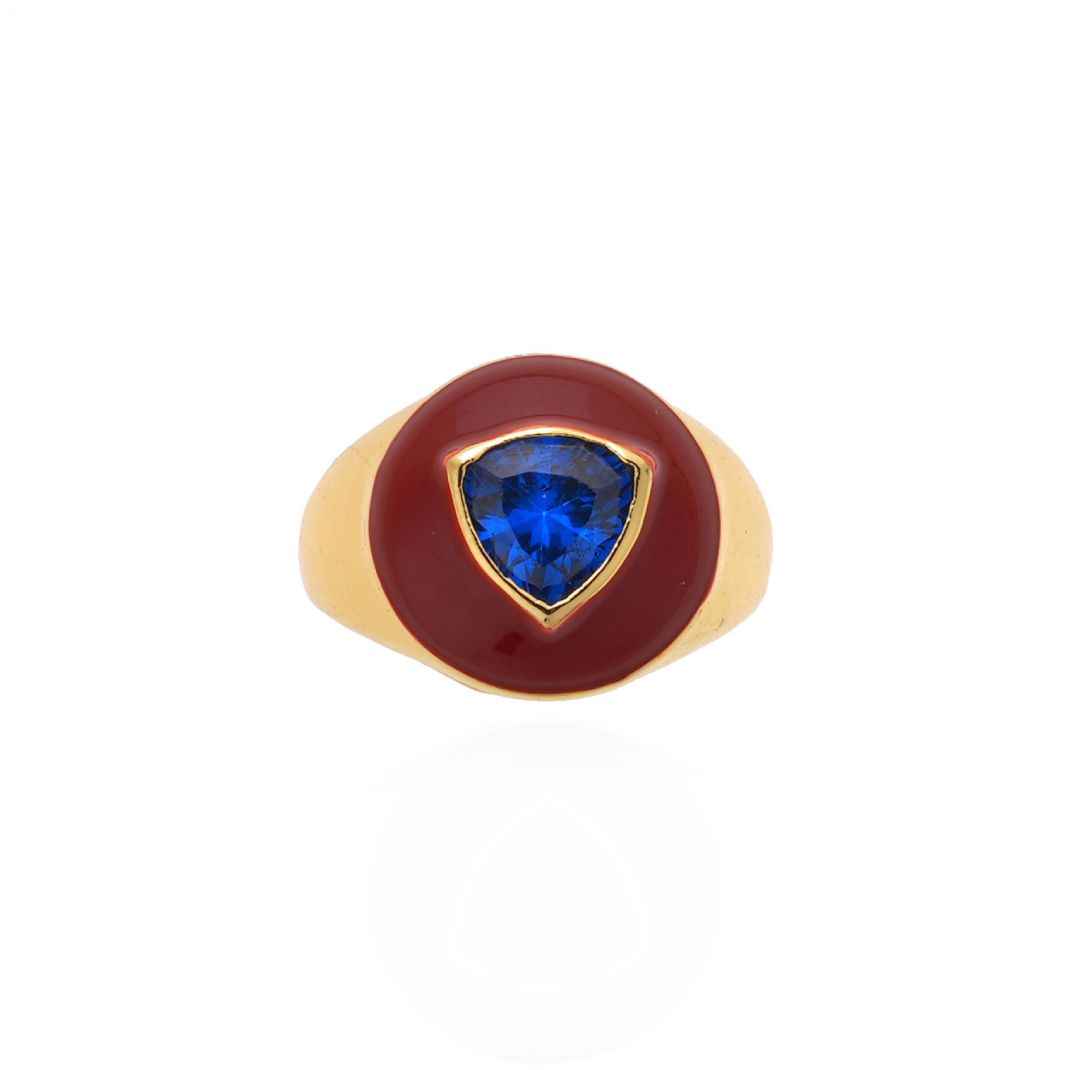 Gold ring with a blue gemstone on a white background