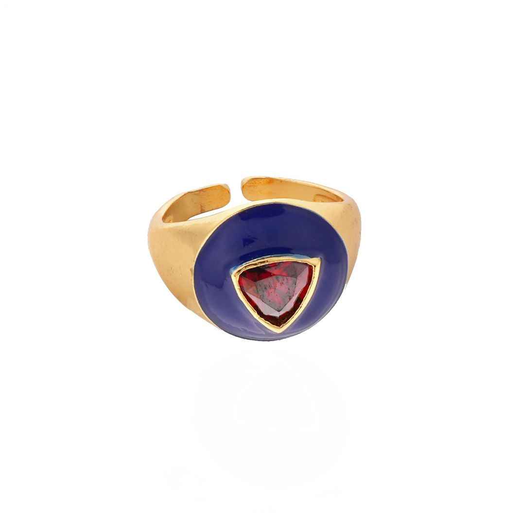 Gold ring with a blue and red gemstone on a white background